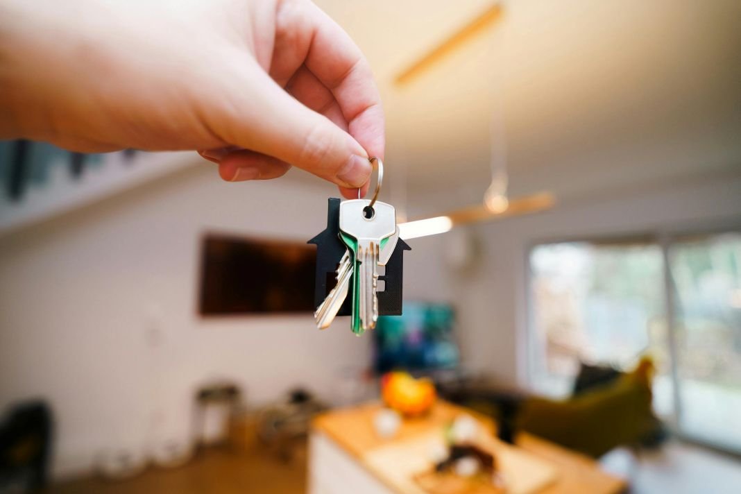 a photo of a landlord holding keys to their property